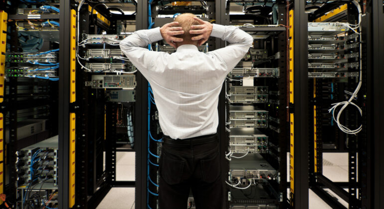 Man,Looking,Astonished,In,A,Network,Data,Center.